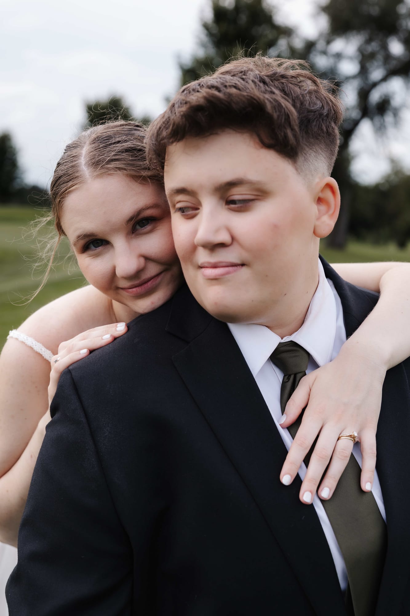 Ruth and Emily embracing, one resting her head on the other's shoulder